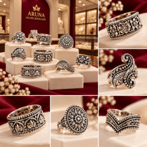 Collection of ornate oxidized silver-tone rings featuring floral engravings, paisley patterns and intricate decorative details displayed on cream jewellery stands.
