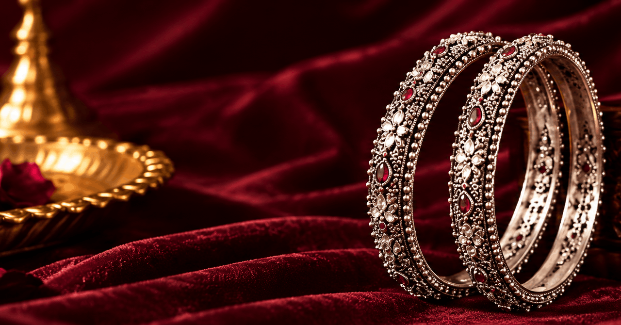 raditional silver bangles with red stones displayed on burgundy velvet by Aruna Silver Jewellery