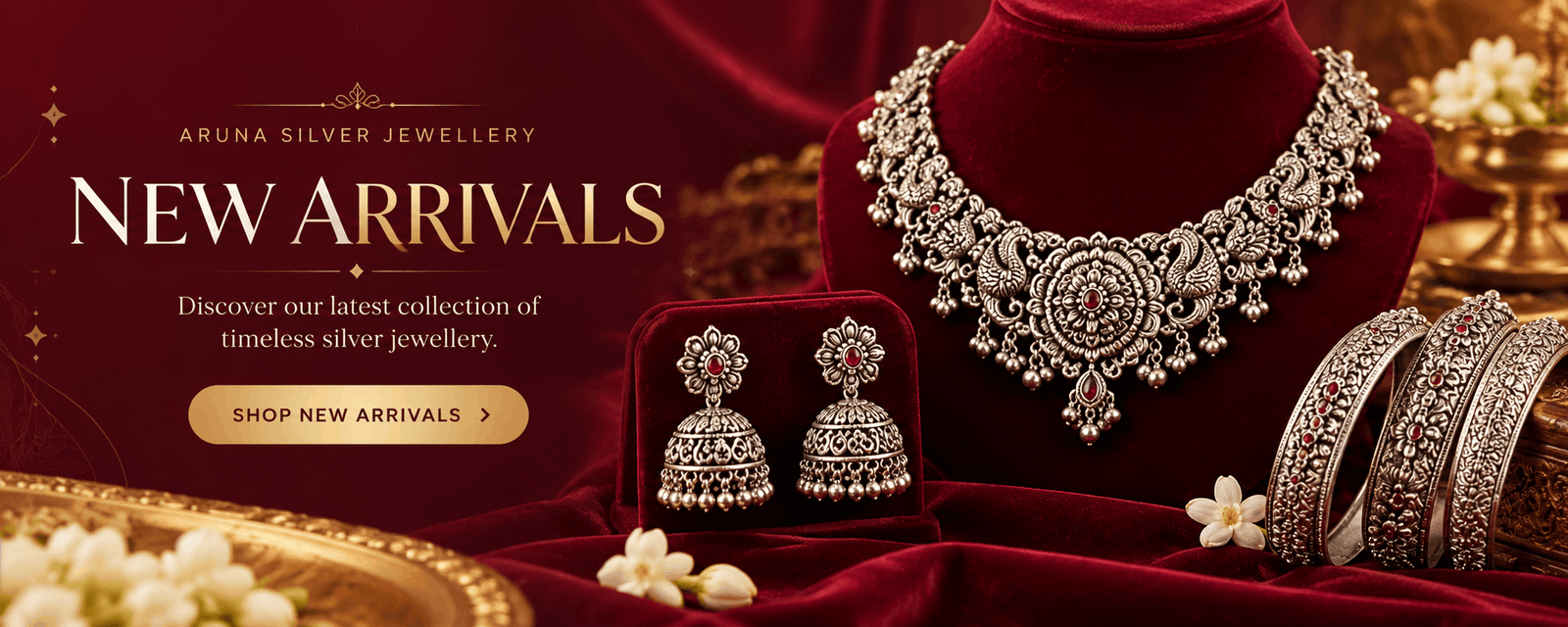 Aruna Silver Jewellery new arrivals banner featuring a traditional silver necklace, jhumka earrings and decorative bangles on burgundy velvet.
