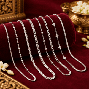 Multiple elegant silver chain designs displayed on a burgundy velvet jewellery stand with gold decorative accents.